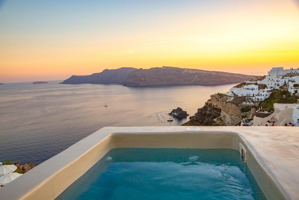 Plunge pool with sunset caldera view at Kaleidoscope Cave Houses, Oia Santorini