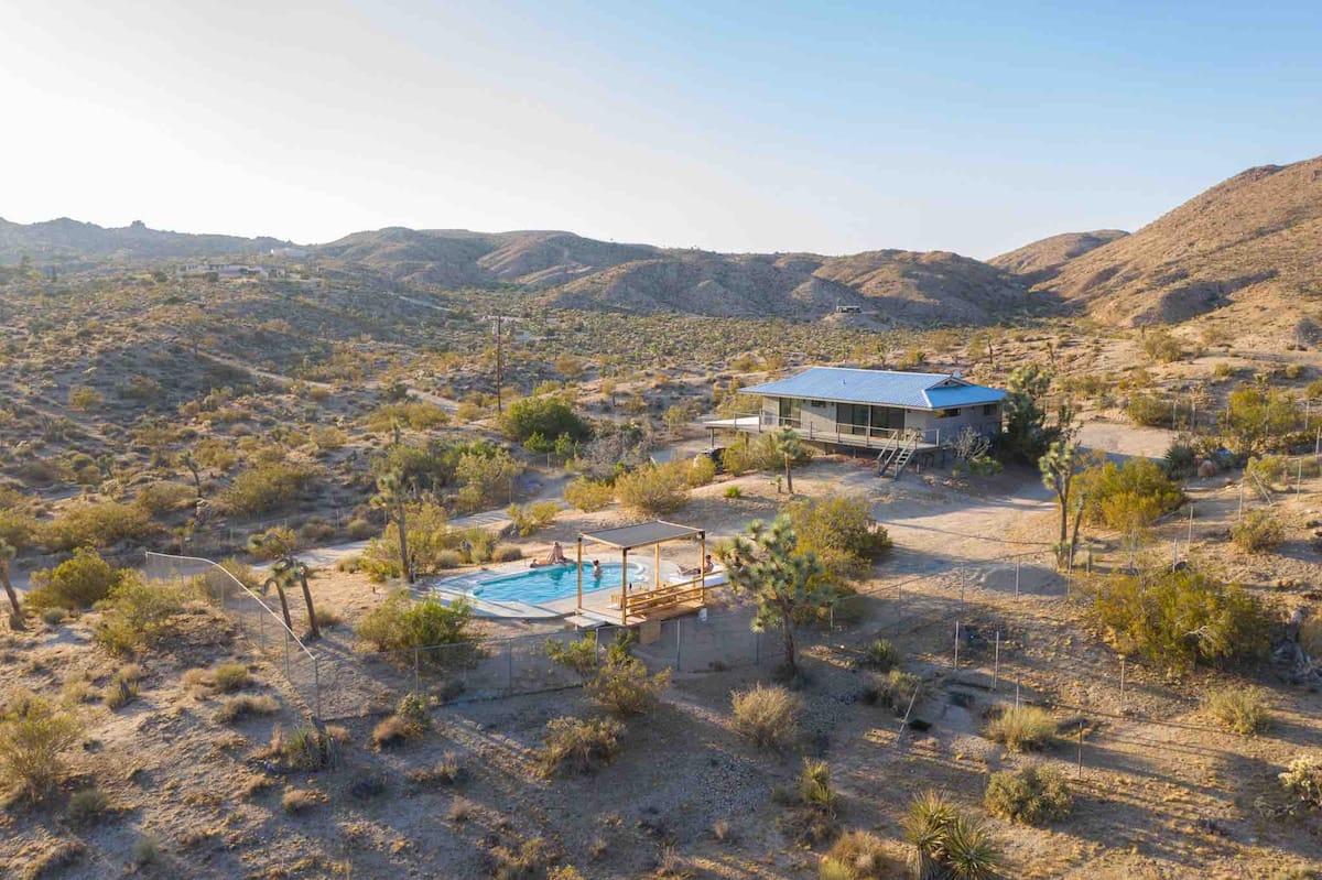 The Joshua Tree Prescott House pool with desert and mountain views, one of the best Airbnbs in Joshua Tree, California