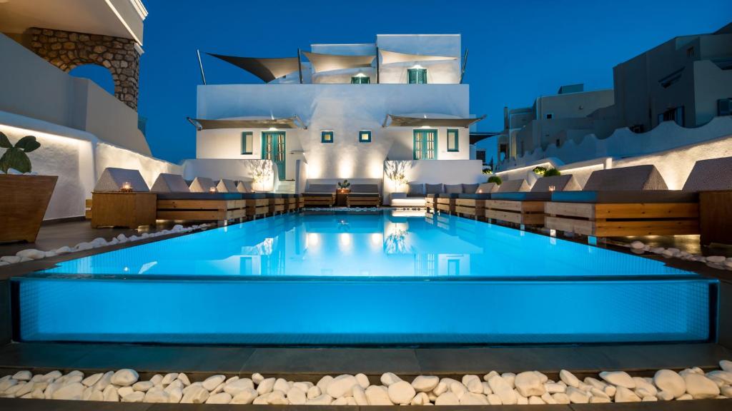 Swimming pool between the whitewashed buildings of Evgenia Villas, Fira Santorini
