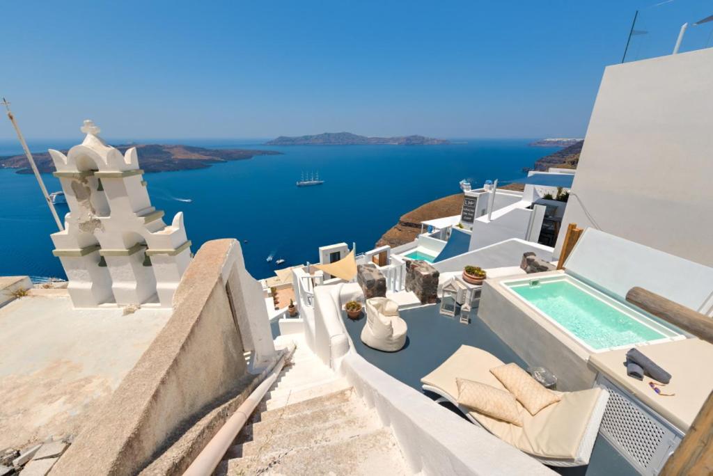 Terrace plunge pool with church bell tower and caldera view at Fira White Residence, Santorini