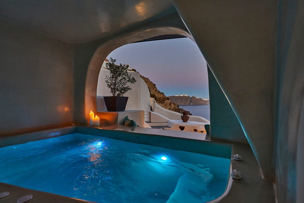 Private cave hot tub with caldera view at Stellar Sun Suite, one of the best Airbnbs in Santorini Greece