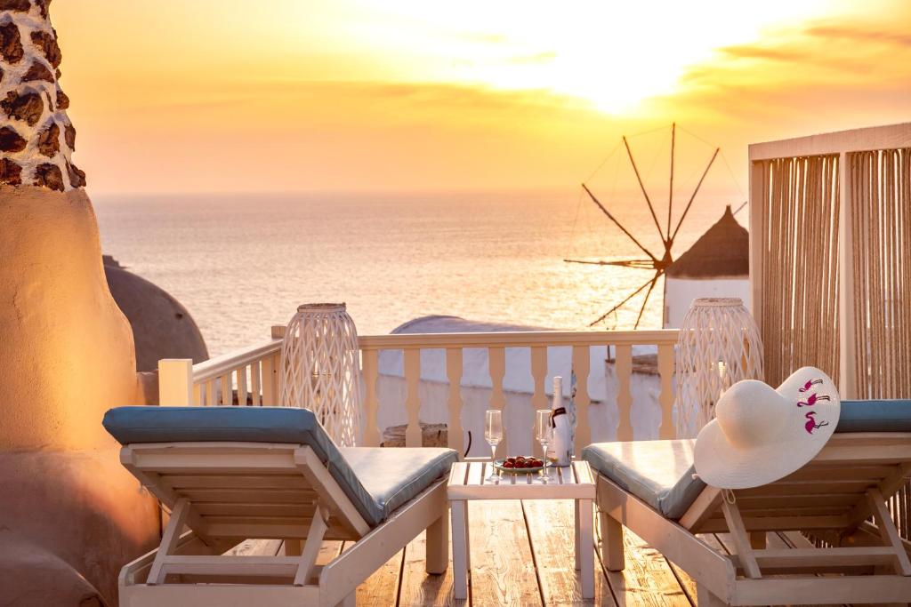 Balcony with chairs overlooking the ocean at Thetis Cave Houses, Oia Santorini