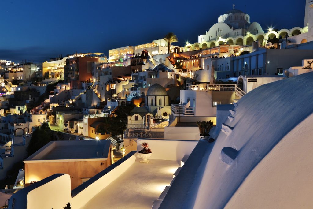 Fira lit up at night, viewed from the terrace of Trieris Villa, Santorini