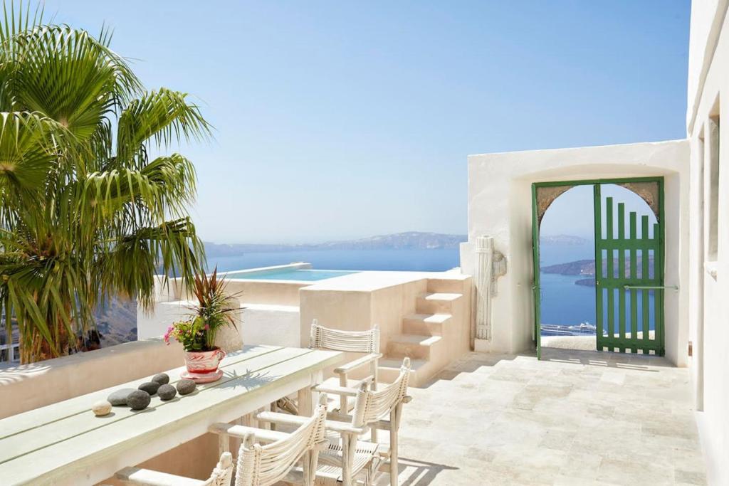 Patio with table and chairs overlooking the ocean at Villa Murat, Fira Santorini